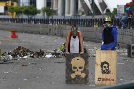 Opposition supporters stand behind a barricade as the Constituent Assembly election was being carried out in Caracas