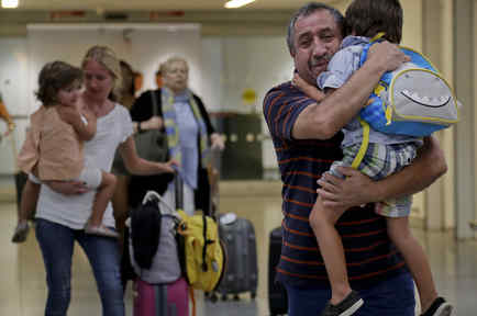 Un abuelo en New York carga a su nieto quien evacuó Puerto Rico junto co su mamá y hermana