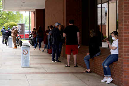 People who lost their jobs wait in line to file for unemployment following an outbreak of the coronavirus disease (COVID-19), at an Arkansas Workforce Center in Fort Smith, Arkansas, U.S. April 6, 2020