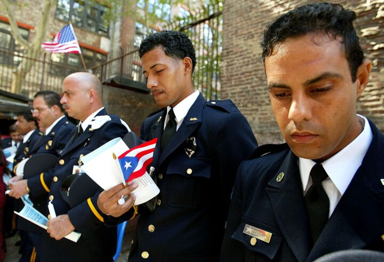 Integrantes del Puerto Rico Urban Search and Rescue Task Force, que fue impulsado por el bombero Dennis Mojica, fallecido el 11 de septiembre de 2001, rinde honores a rescatistas que perdieron la vida en el atentado un año después, en 2002.