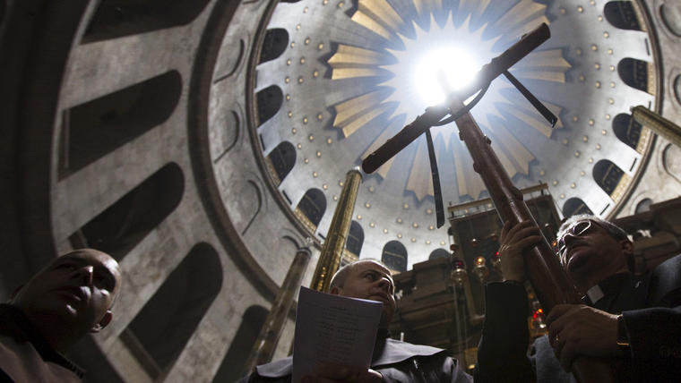 Members of the clergy take part in a prayer after a procession in the Church of the Holy Sepulchre on Good Friday, during Holy Week in Jerusalem's Old City 