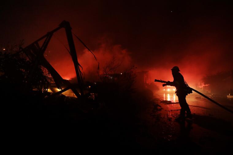 Los bomberos trabajan entre las casas destruidas en Fallbrook, California. 