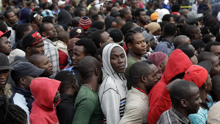En esta imagen del 3 de octubre de 2016, haitianos se forman en una agencia migratoria en Tijuana, México, con la esperanza de obtener una cita para cruzar hacia el lado estadounidense de la frontera.