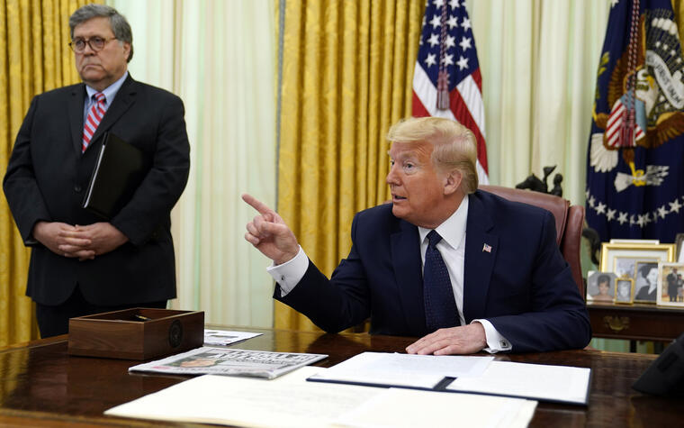 Trump, en el Despacho Oval de la Casa Blanca durante la firma el jueves de la orden ejecutiva sobre redes sociales. A la izquierda, el fiscan general, William Barr. 