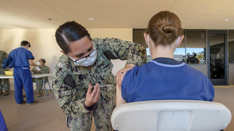 En esta fotografía provista por la Marina de Estados Unidos, la suboficial Jasmin Fiorini suministra una vacuna en el Centro Médico Naval de San Diego en diciembre. 
