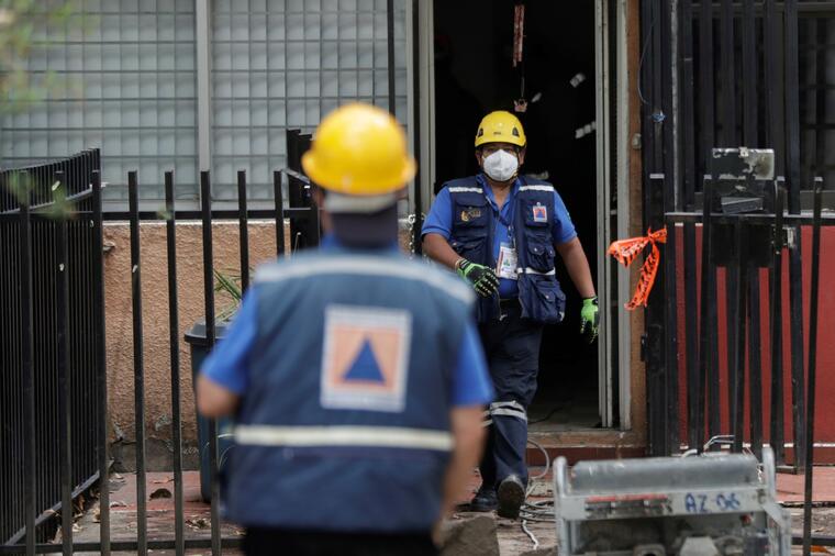 Agentes de Protección Civil revisan un edificio dañado por el sismo de 7.4 grados en junio en México.