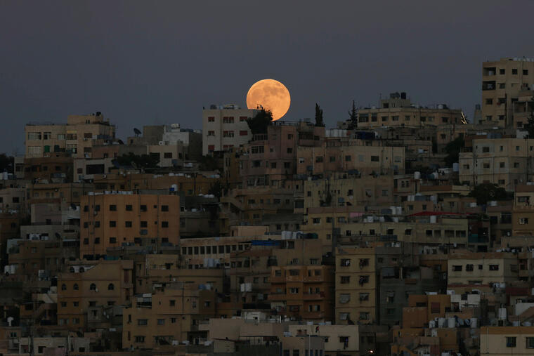 The moon is seen before a lunar eclipse over Amman