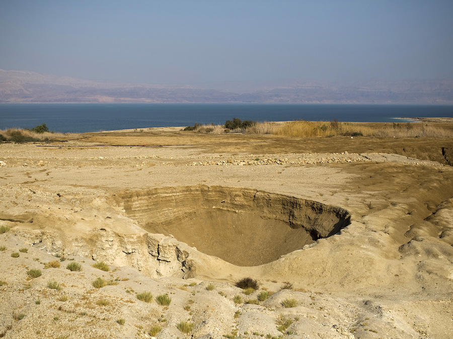 A sinkhole is seen on the shore of the Dead Sea